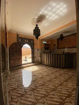 an open hallway with an archway in a building at Dar Ilyana in Tamezmoute