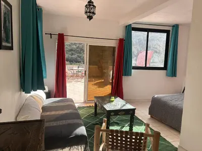 a living room with a couch and a table at Chez Yahia, Au coeur de L'Ourika in Ourika