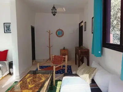 a living room with a couch and a glass table at Chez Yahia, Au coeur de L'Ourika in Ourika