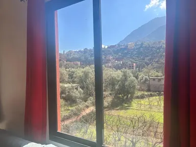 a window with a view of a mountain view at Chez Yahia, Au coeur de L'Ourika in Ourika