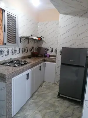 a kitchen with a stove and a refrigerator at La Perle in Meknès