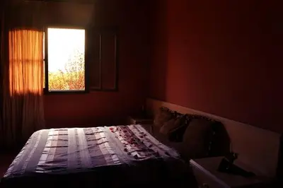 a bedroom with a bed and a window at Villa Paradise in Aghmat