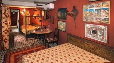 a room with a bedroom with a table and a bed at Riad Lune et Soleil in Fès