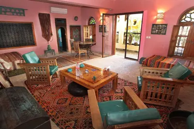 a living room with a table and chairs at Riad Lune et Soleil in Fès