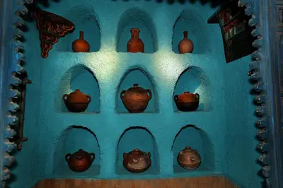 a bunch of vases on a blue wall at Riad Lune et Soleil in Fès