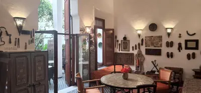 a bedroom with a bed and a table in a room at Riad Lune et Soleil in Fès