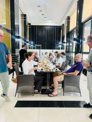 a group of people sitting around a table at Hotel La Luna in Beni Mellal