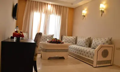 a living room with a couch and a table at Hotel La Luna in Beni Mellal