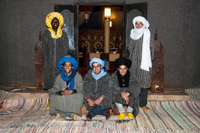 a group of people posing for a picture in a room at Madu Luxury Desert Camp in Merzouga