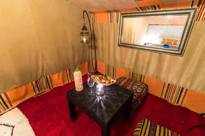 a room with a table with a bowl of fruit on it at Madu Luxury Desert Camp in Merzouga