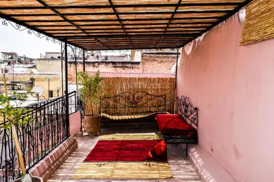 a balcony with a red bed on a building at Dar Nineta in Fès