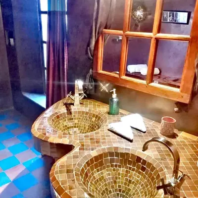 a bathroom with a sink and a mirror at Les Bains de Fez Tara in Fès