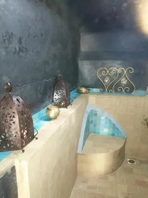 a room with a bath tub with blue tiles at Les Bains de Fez Tara in Fès
