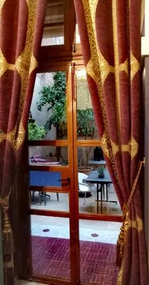 a door with a curtain in front of a room at Les Bains de Fez Tara in Fès