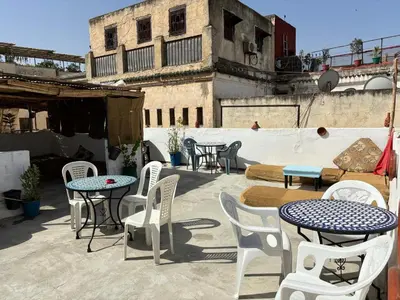 a group of tables and chairs on a patio at BackHome Fez in Fès