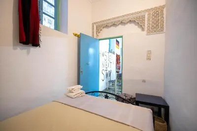 a small room with a bed and a window at BackHome Fez in Fès