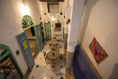 an overhead view of a room with tables and chairs at BackHome Fez in Fès