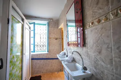a bathroom with two sinks and two windows at BackHome Fez in Fès