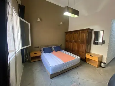 a bedroom with a bed with blue pillows at Appartement en plein centre ville in Fès