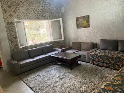 a living room with a couch and a coffee table at Appartement en plein centre ville in Fès