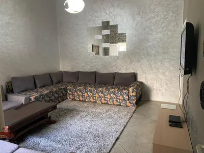 a living room with a couch and a television at Appartement en plein centre ville in Fès