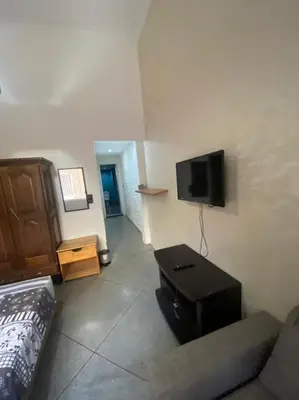 a living room with a couch and a flat screen tv at Appartement en plein centre ville in Fès