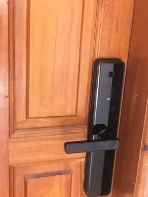 a wooden door with a phone sticking out of it at Vittel Ifrane Large and Beautiful Apartment in Ifrane