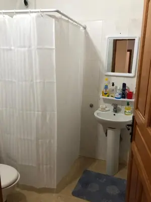 a bathroom with a shower curtain and a sink at Vittel Ifrane Large and Beautiful Apartment in Ifrane