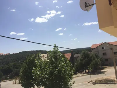 a view of a street with a tree and buildings at Vittel Ifrane Large and Beautiful Apartment in Ifrane