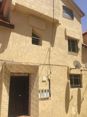 a brown building with a door and windows at Vittel Ifrane Large and Beautiful Apartment in Ifrane