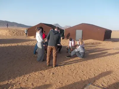 a group of people standing in the desert at Bivouac Draa in Zagora