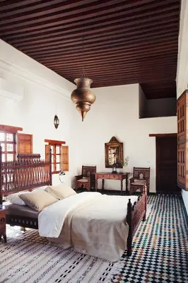 a bedroom with a large bed and a wooden ceiling at Dar Seffarine in Fès