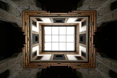a ceiling view of a building with a window at Dar Seffarine in Fès