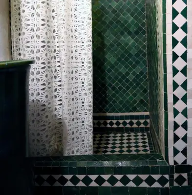 a shower with a green and white shower curtain at Dar Seffarine in Fès