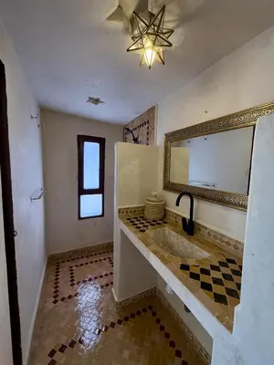 a bathroom with a large tub and a mirror at Royal Sands Camp - Erg Chigaga Luxury Camp in Mhamid