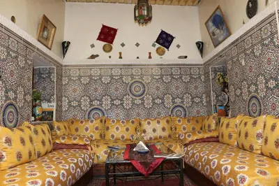 a living room with a couch and patterns on the walls at Dar Najia in Fès