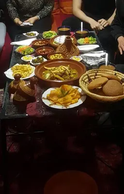 a table with plates of food on it at Dar Najia in Fès