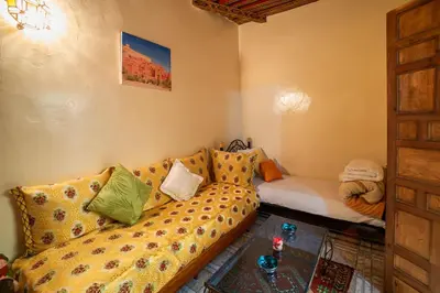 a living room with a couch with pillows at Dar Najia in Fès