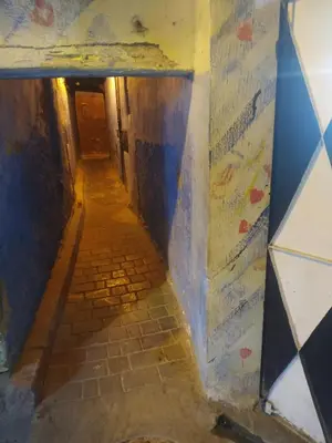 an alley way in a building with colorful walls at Dar Najia in Fès