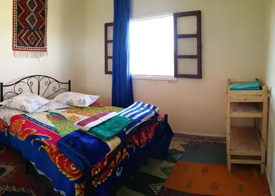 a bedroom with a bed and a window at Gite Kasbah La Palmeraie in Skoura
