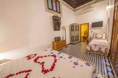 a bedroom with a bed with a red heart on it at Riad Ouliya in Fès