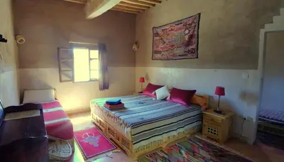 a small bedroom with a bed and a window at Dar Jnane - La Maison Du Jardin in Agdz