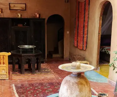 a living room with a table and a table sidx sidx sidx at Dar Jnane - La Maison Du Jardin in Agdz