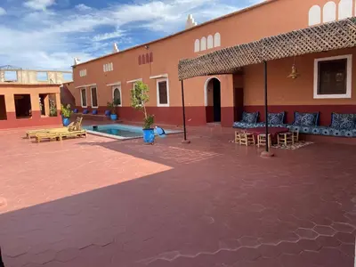 a courtyard of a building with tables and chairs at Auberge Ksar Ait Ben Haddou in Aït Ben Haddou