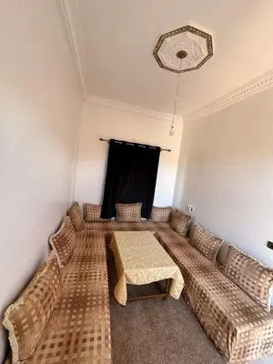 a living room with a couch and a table at Auberge Ksar Ait Ben Haddou in Aït Ben Haddou