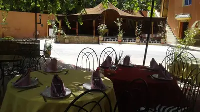 a table with plates and napkins on top at RIAD Camping ATLAS in Tinerhir