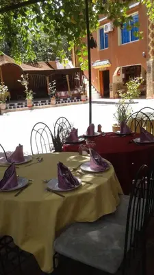 a table with purple napkins on top at RIAD Camping ATLAS in Tinerhir