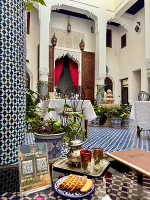 a restaurant with a tray of food on a table at Palais Nazha Fes - Luxury Lodging in Fès