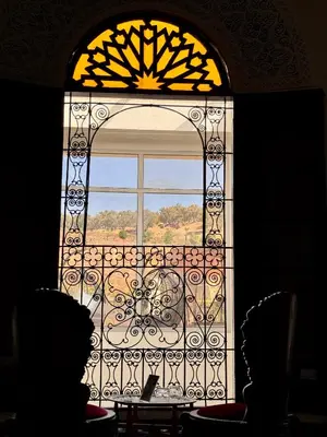 a window with a view of a table in front at Palais Nazha Fes - Luxury Lodging in Fès