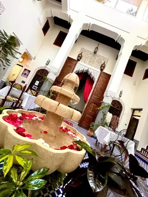 a fountain in the middle of a room at Palais Nazha Fes - Luxury Lodging in Fès